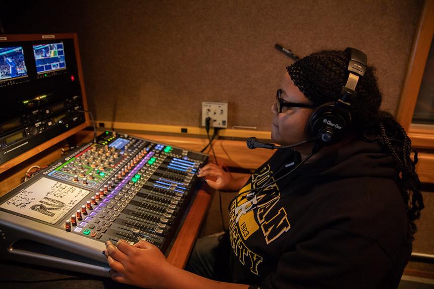 Student working at a media control table.