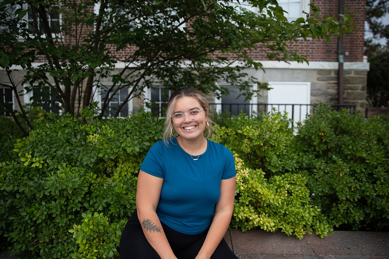 Student sitting by a tree