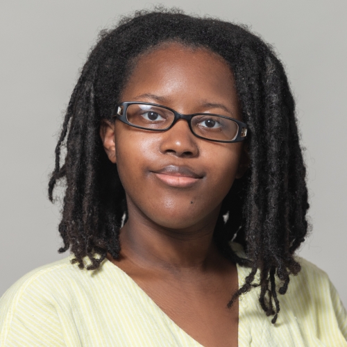 'Aolani Robinson wearing a yellow shirt and black shirt, smiling at the camera.