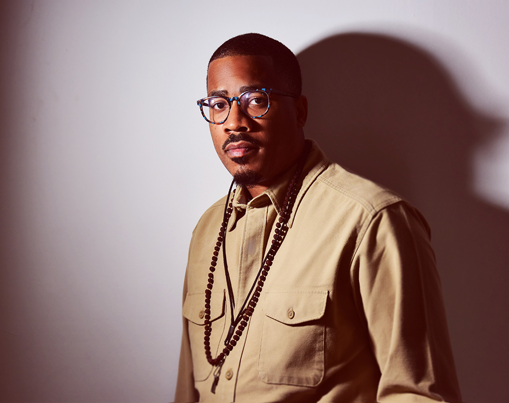 James Brandon Lewis wearing glasses and looking into the camera.