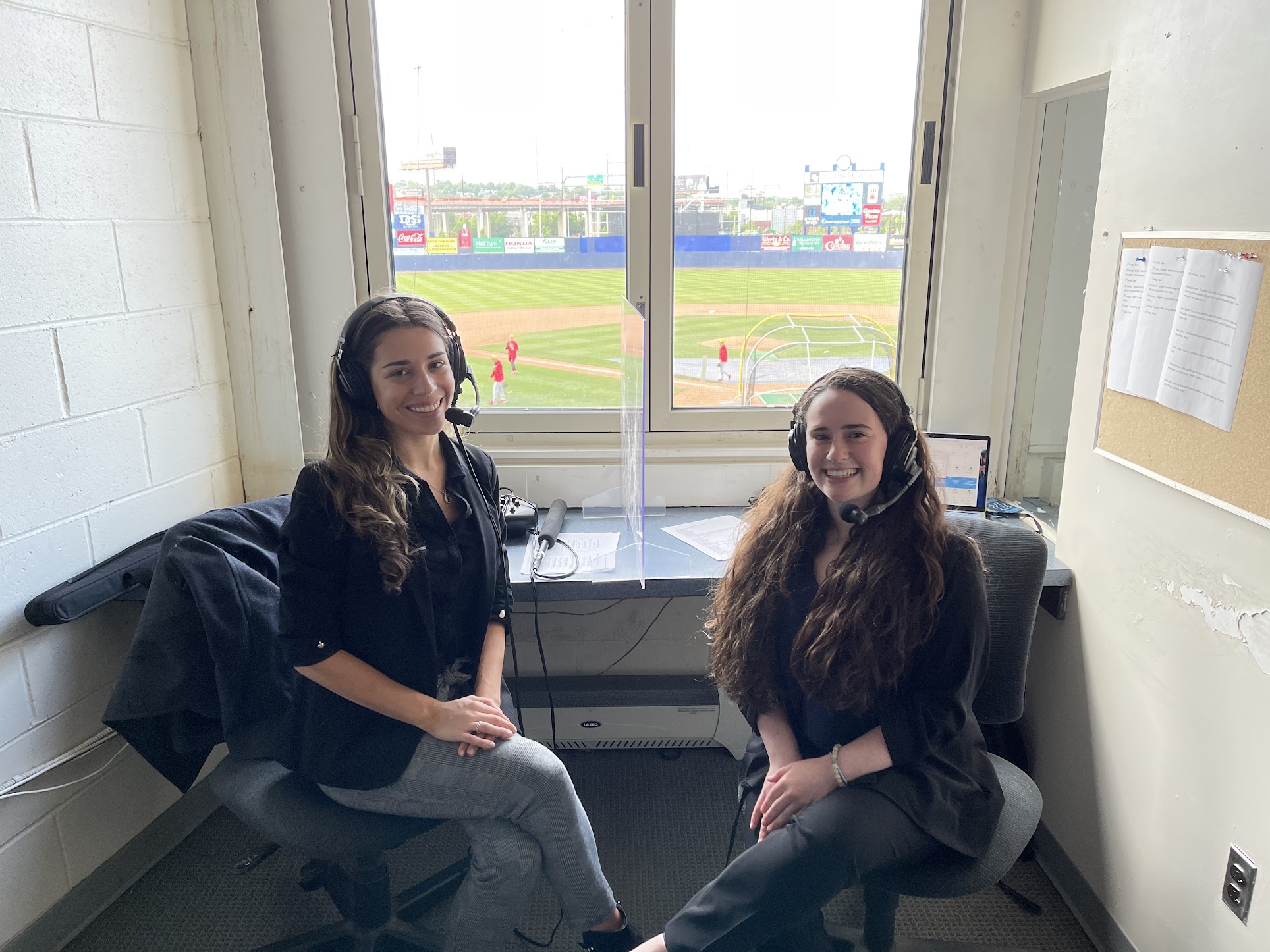 Sports CaM students in announcer box in front of baseball field