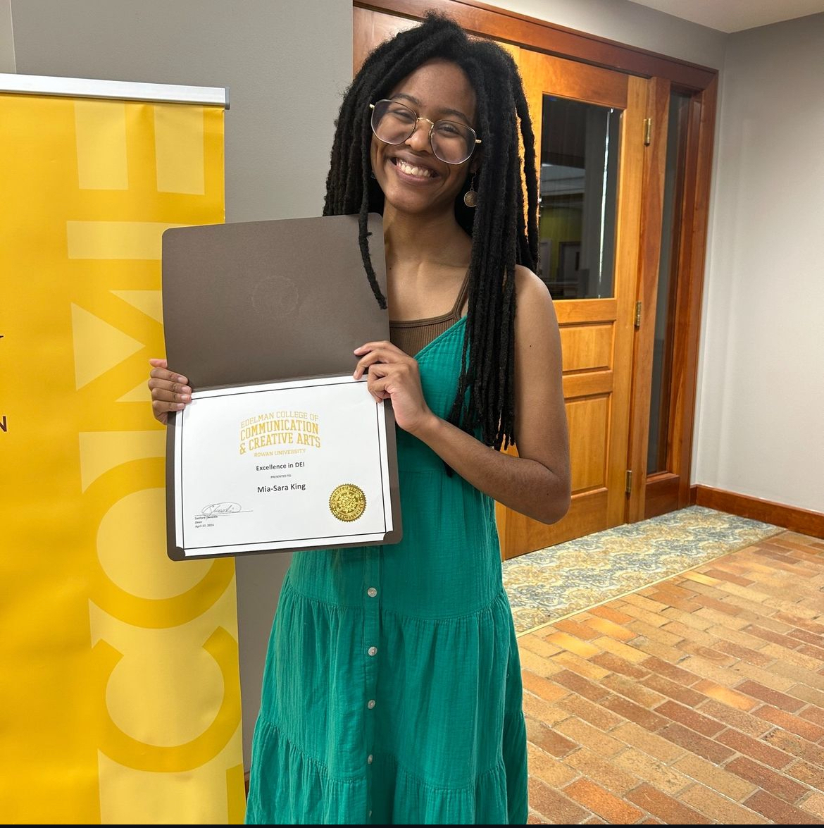 one winner of the dei award holding her certificate